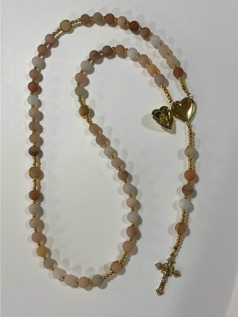 Peach bead rosary with the gold heart locket opened.