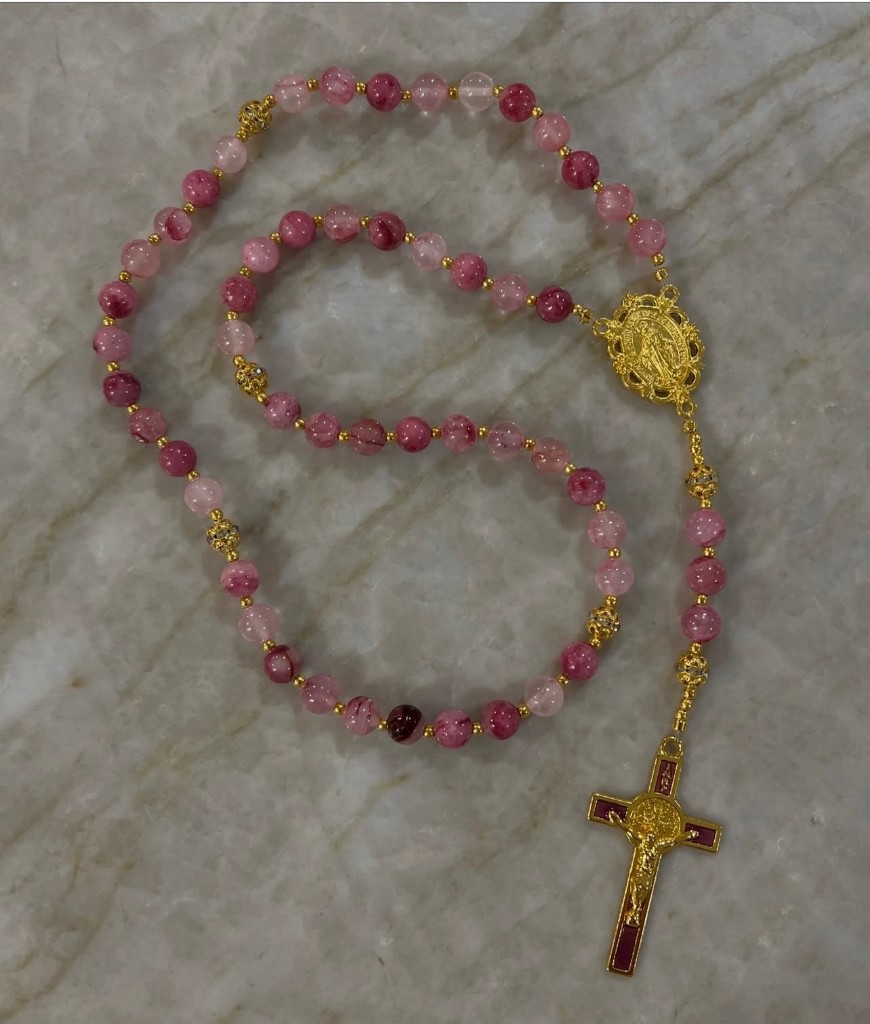 Pink and magenta mixed-bead rosary with gold spacers and a magenta enamel crucifix.
